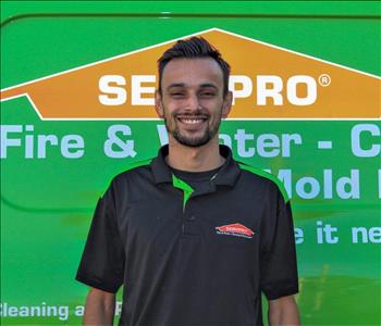 Man in SERVPRO uniform standing in front of a SERVPRO truck