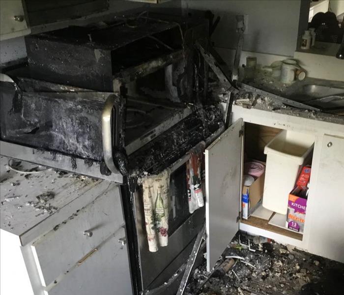 Range in kitchen burned from fire damage.