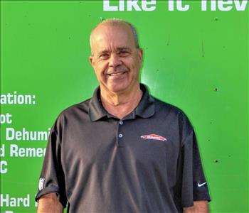 Man in SERVPRO uniform standing in front of a SERVPRO truck