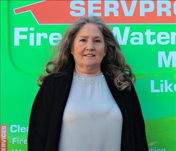 Woman standing in front of a SERVPRO truck